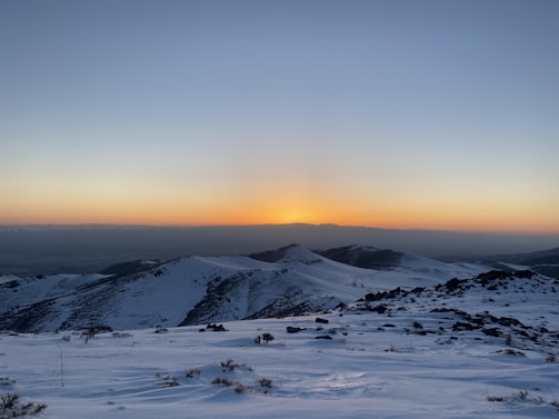 A sunset view over snowy peaks reflecting the calm after a day of coaching and coding.