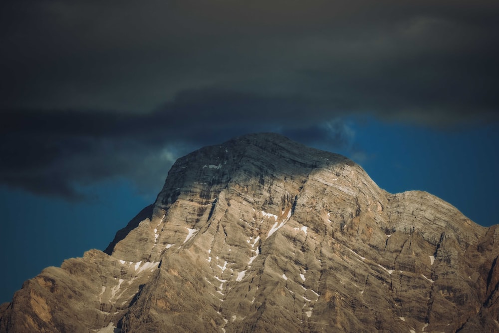 a mountain with a cloudy sky