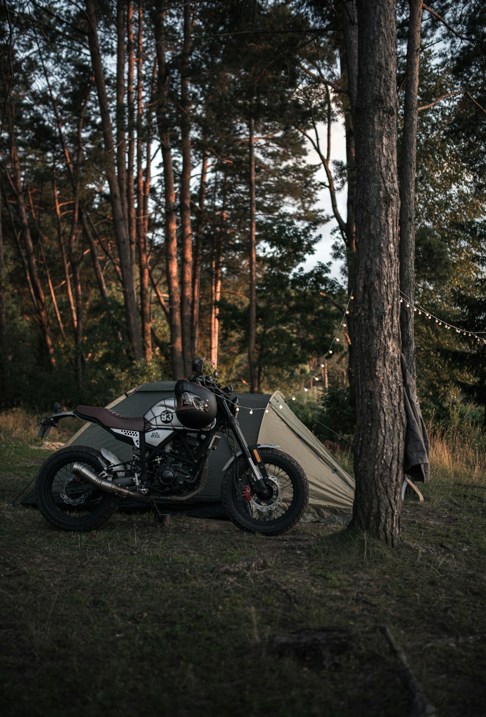 a motorcycle parked next to a tent