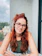 a woman with red hair and glasses