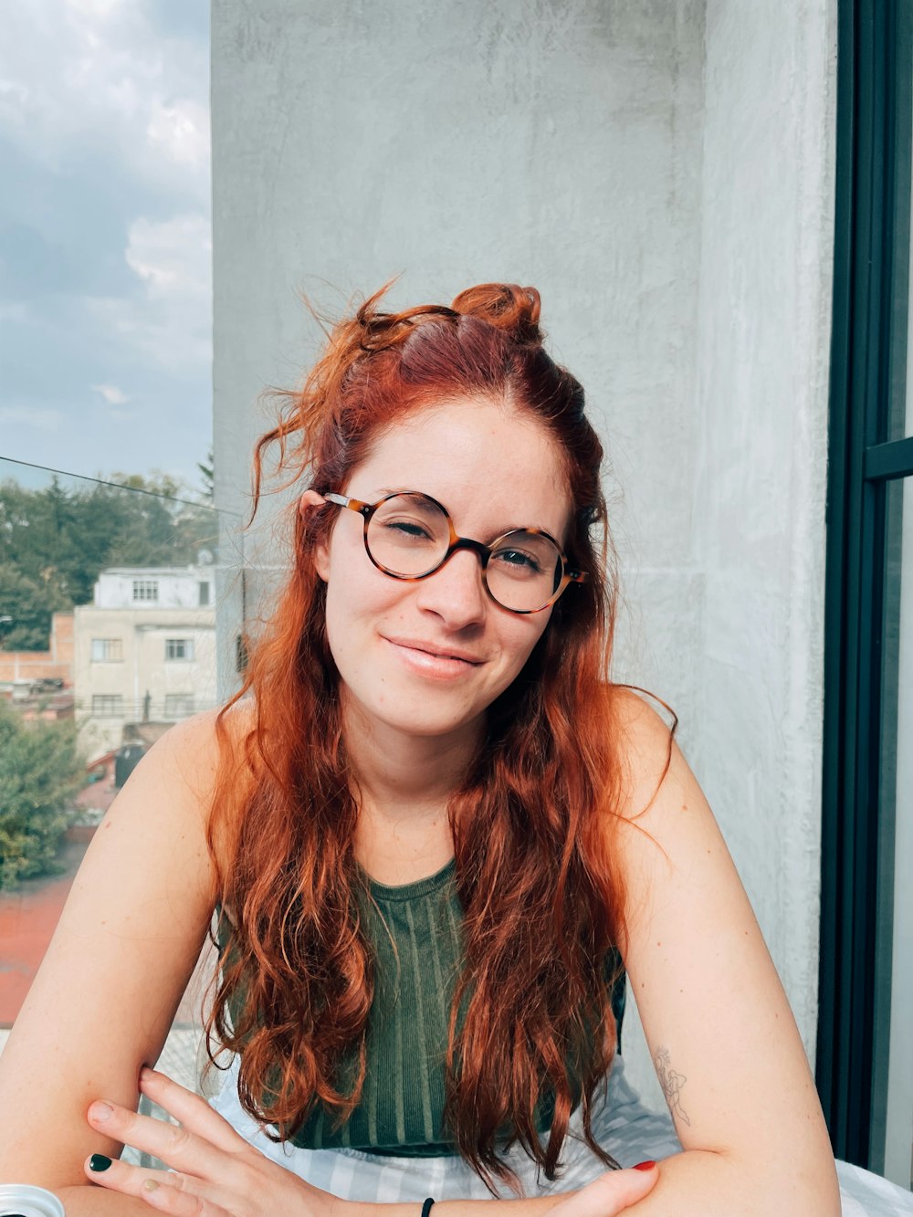 a woman with red hair and glasses