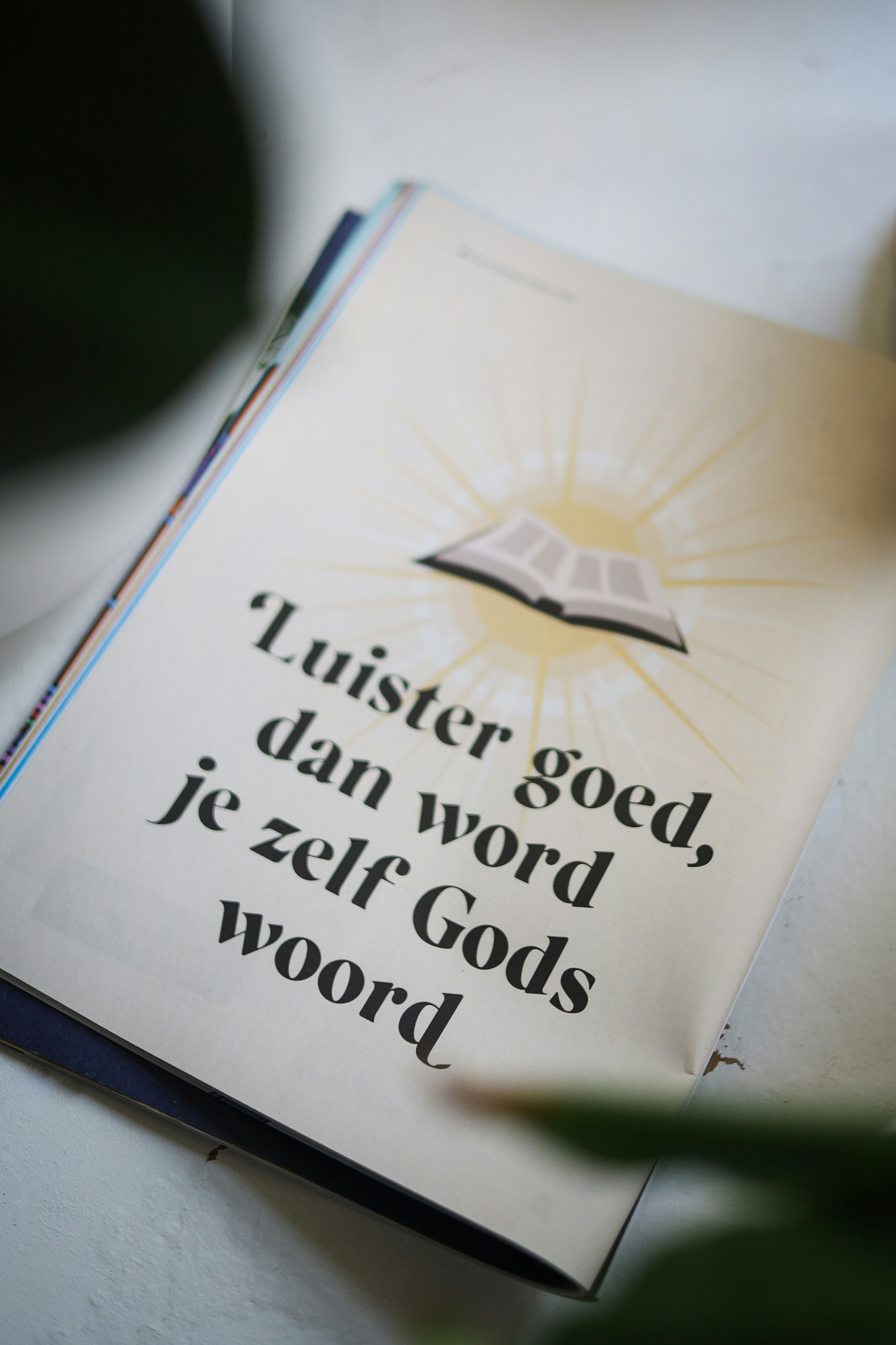 Christian magazine on white table.
