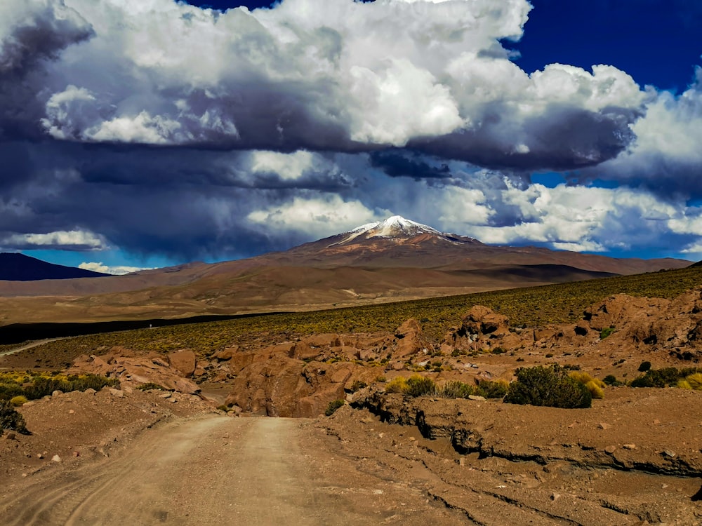 a dirt road leading to a mountain