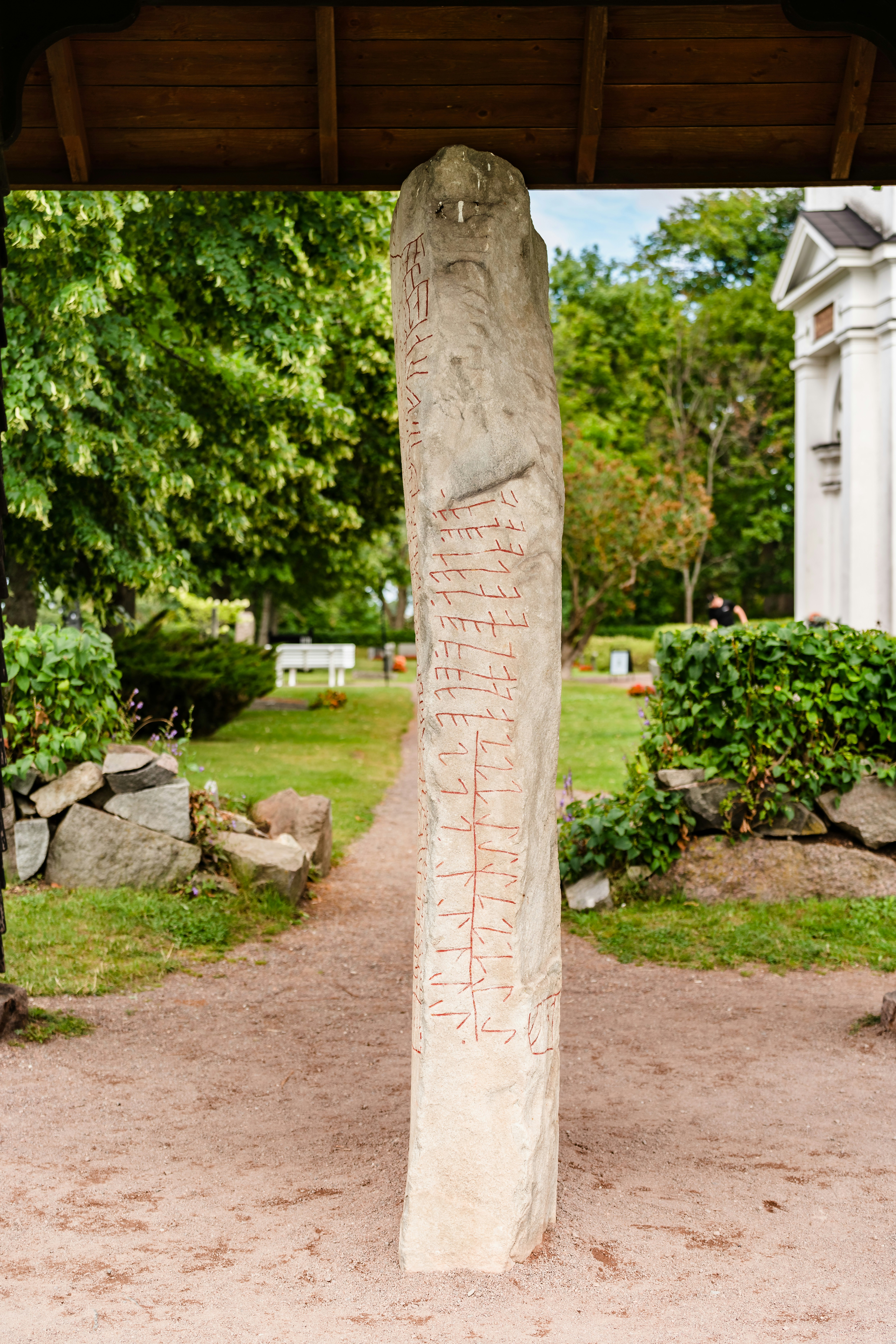 a stone pillar in a garden
