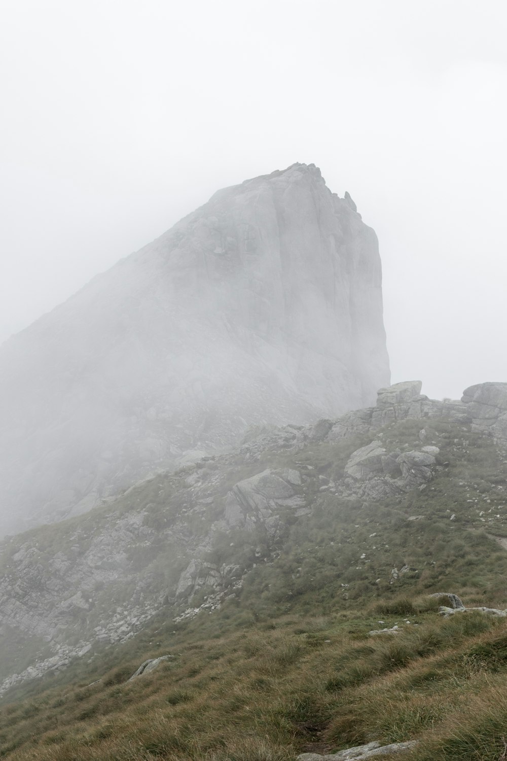 a large mountain with a building on it