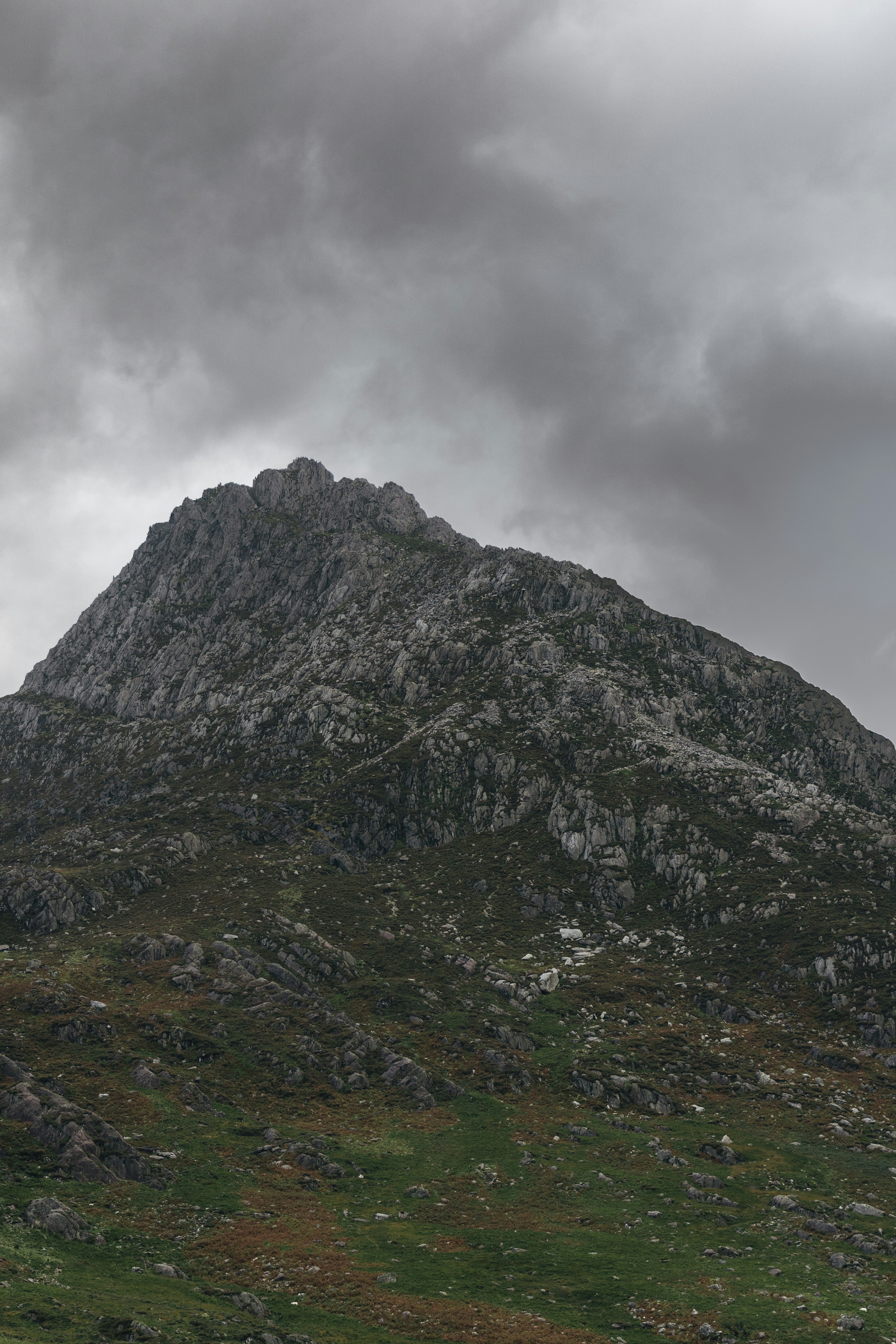 a mountain with a cloudy sky