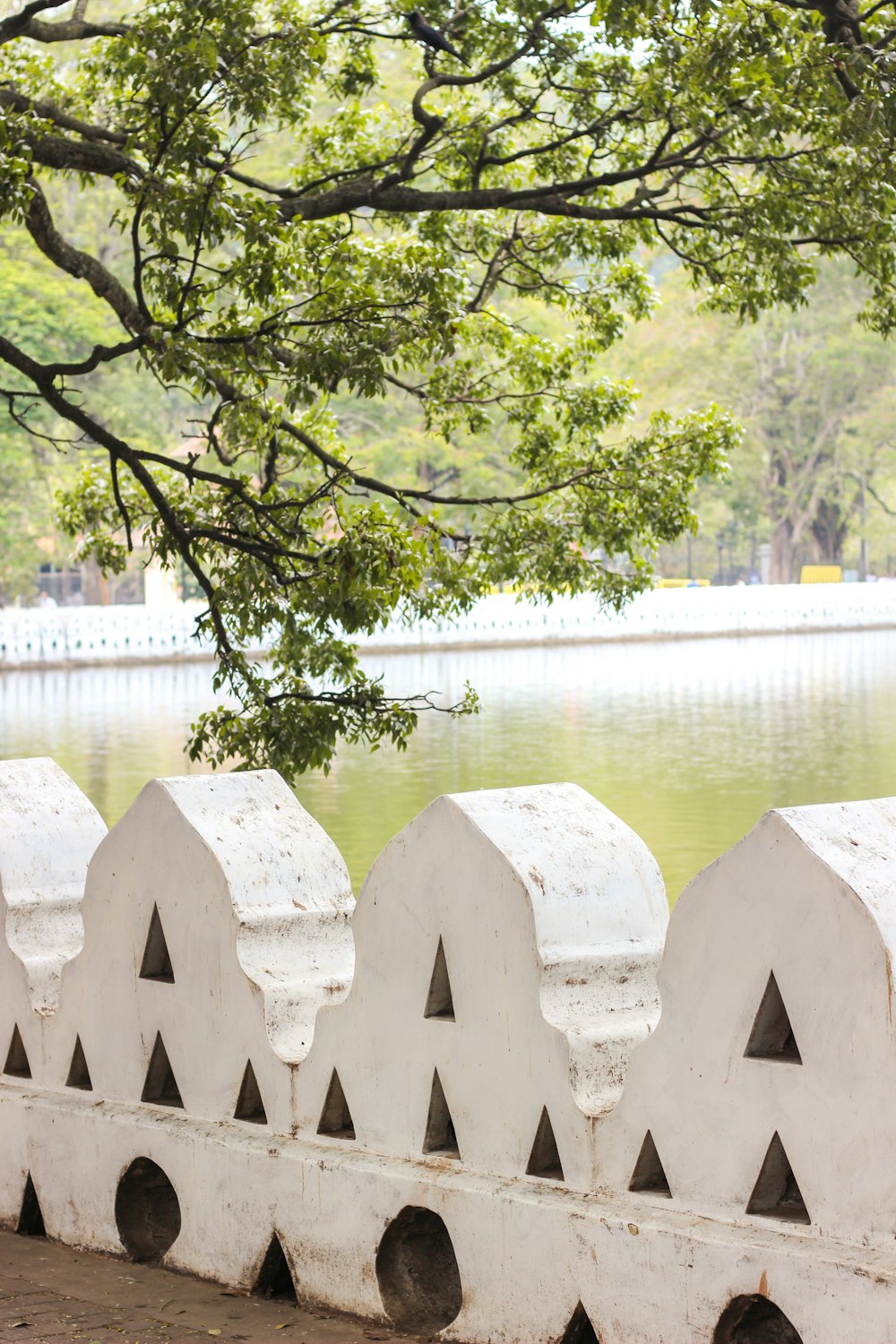 a group of white blocks in front of a pond