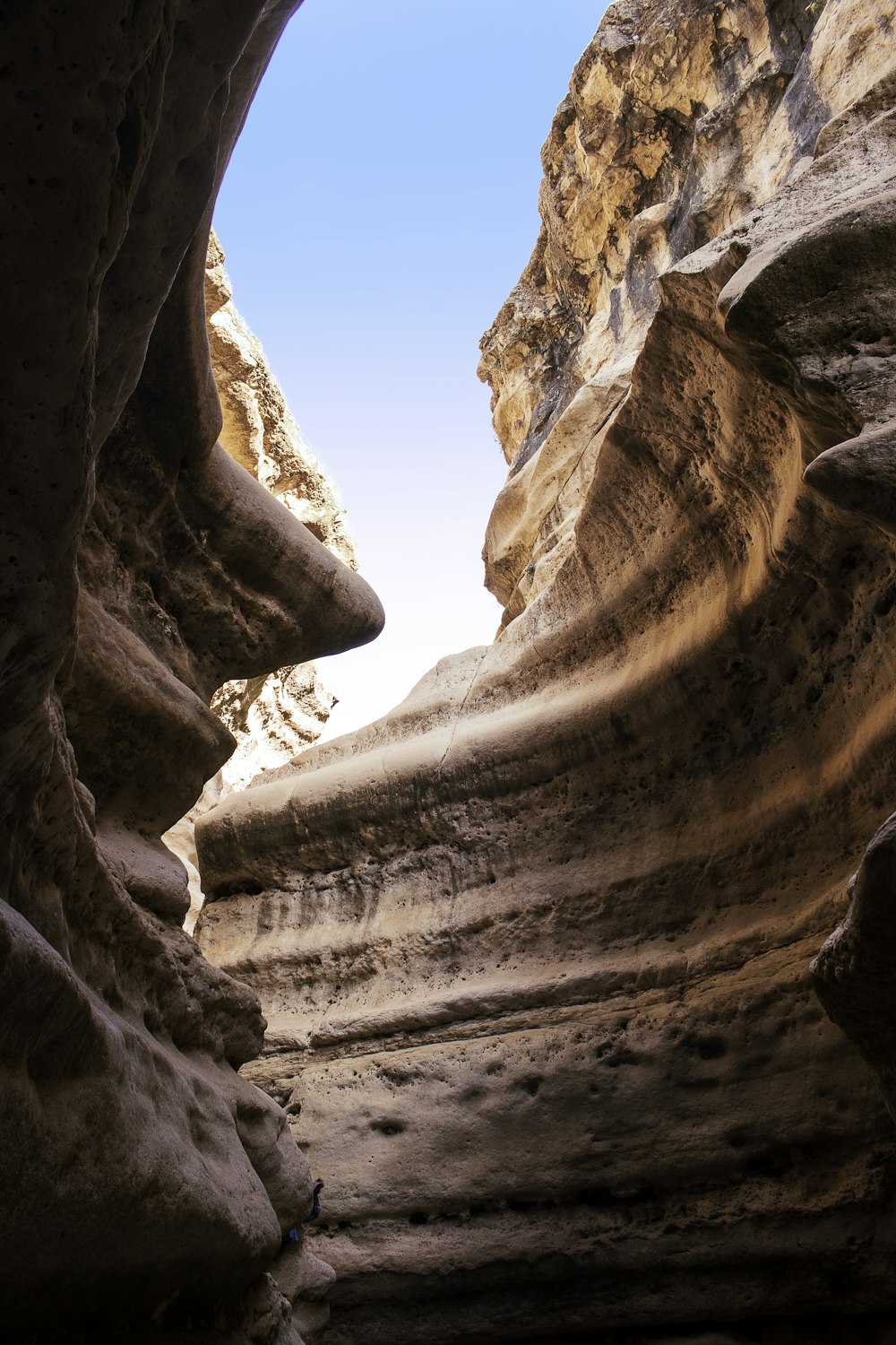 a canyon with a few people walking