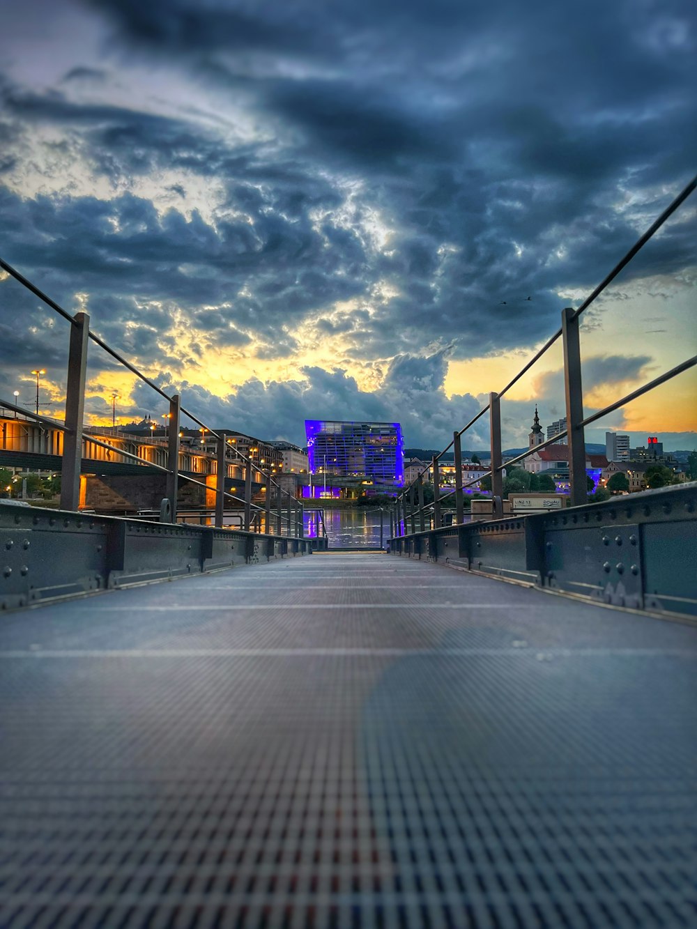 a road with a bridge and buildings on the side