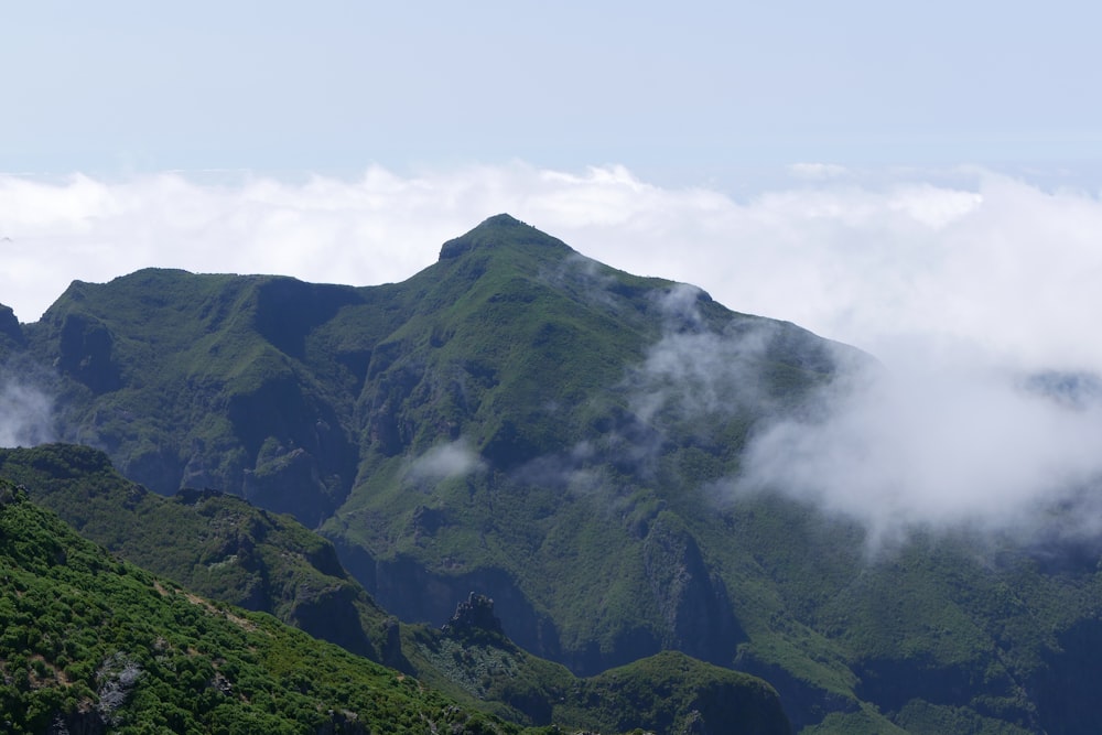 a mountain with clouds around it