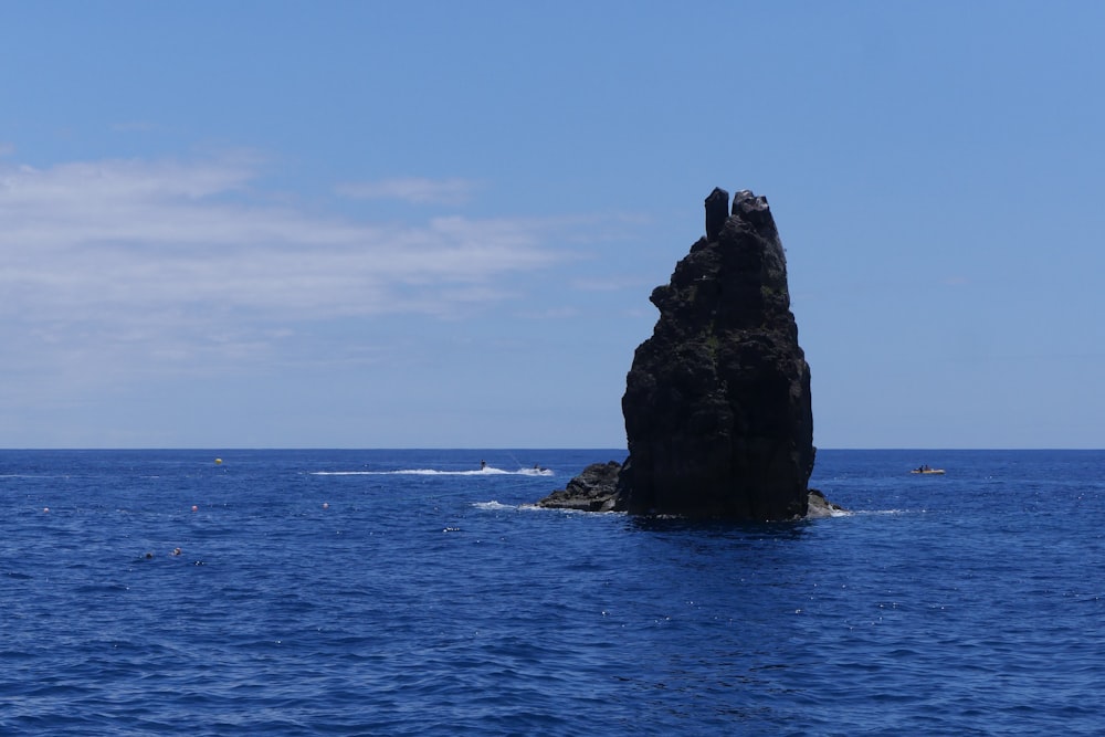 a rock in the middle of the ocean