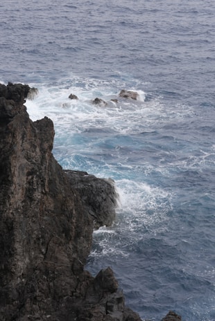 The rugged cliffs and waves crashing at El Fronton, showcasing dramatic coastal beauty.
