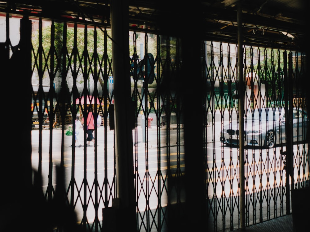 a gate with a group of people in the background