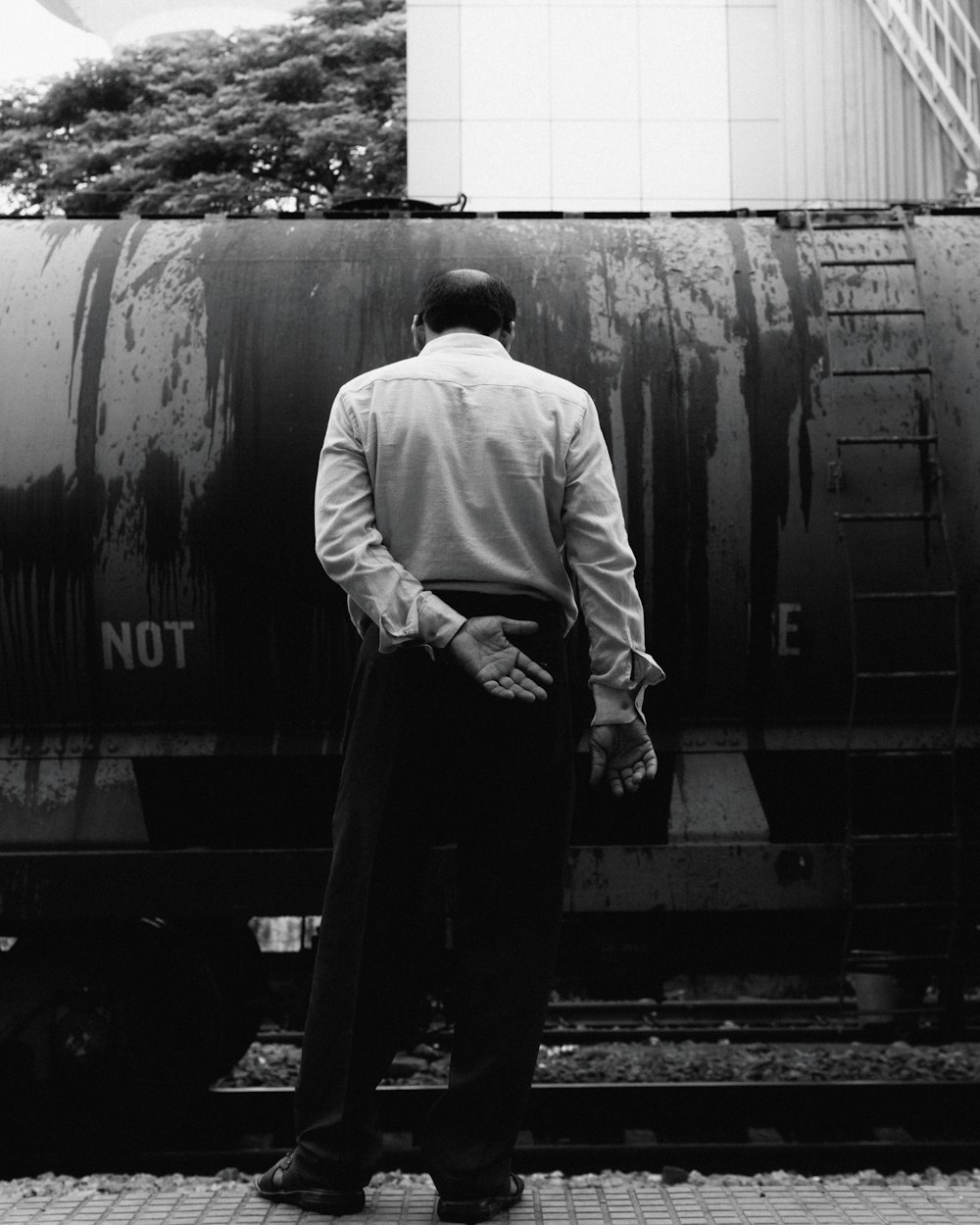 a man standing next to a train