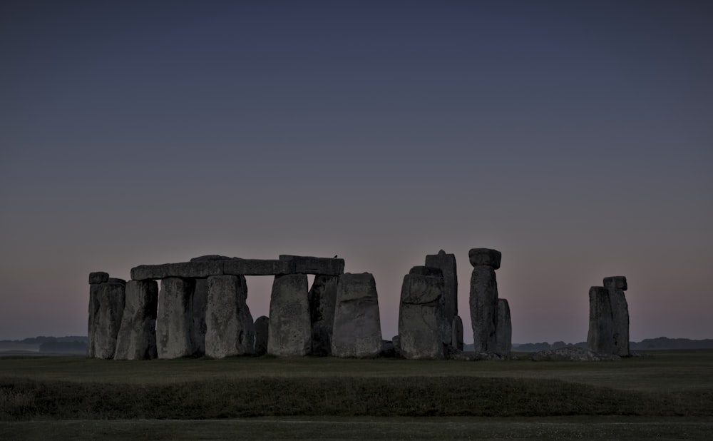 a stone building with Stonehenge in the background