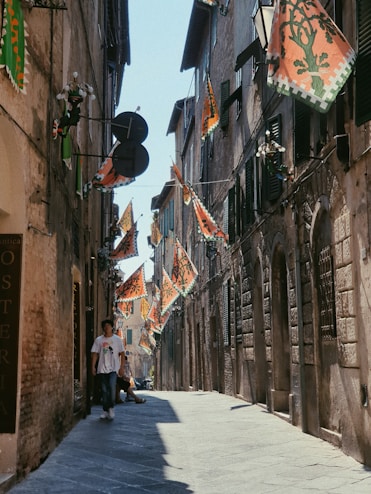 a person walking down a narrow street