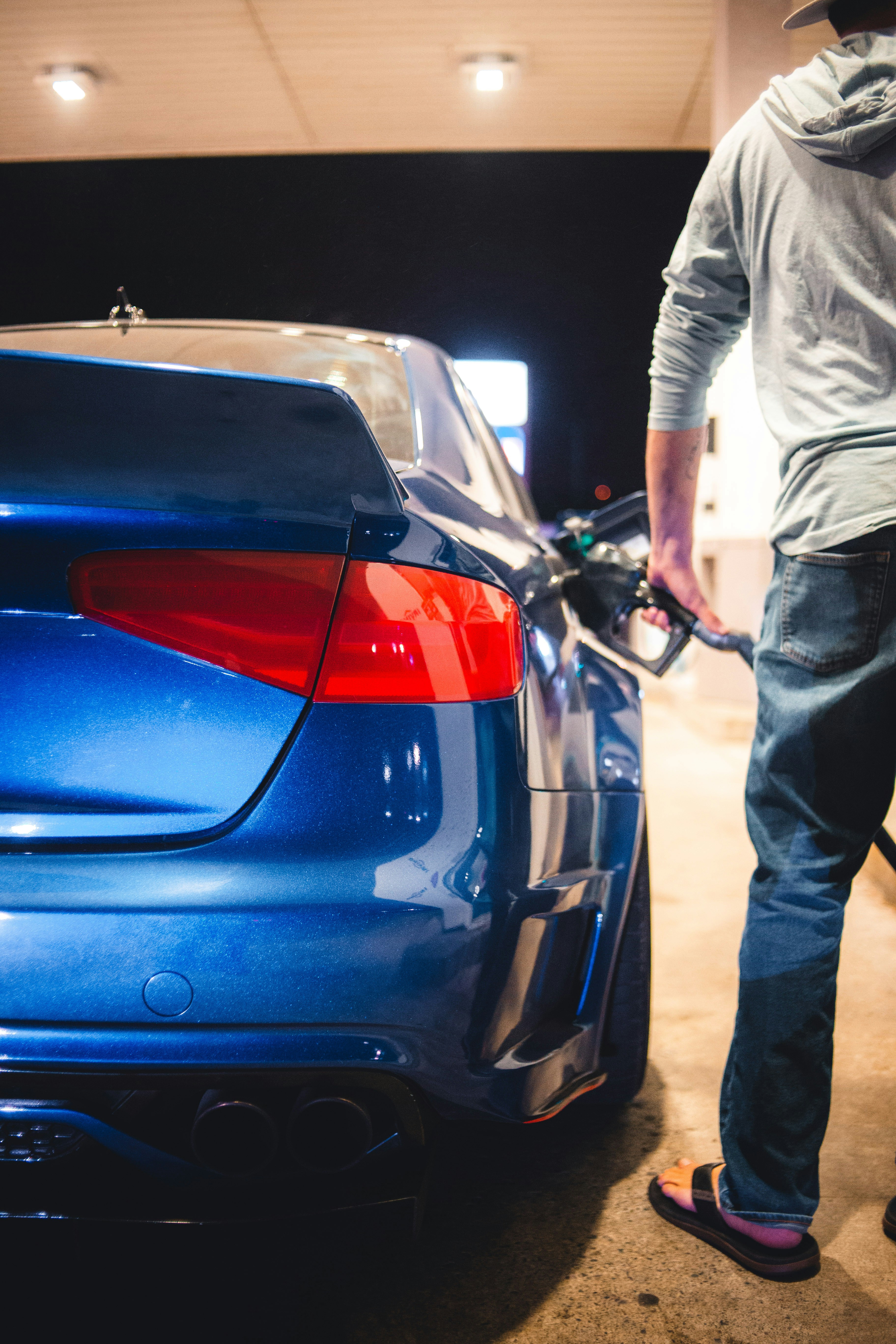 A luxury car being inspected and cleaned before transport