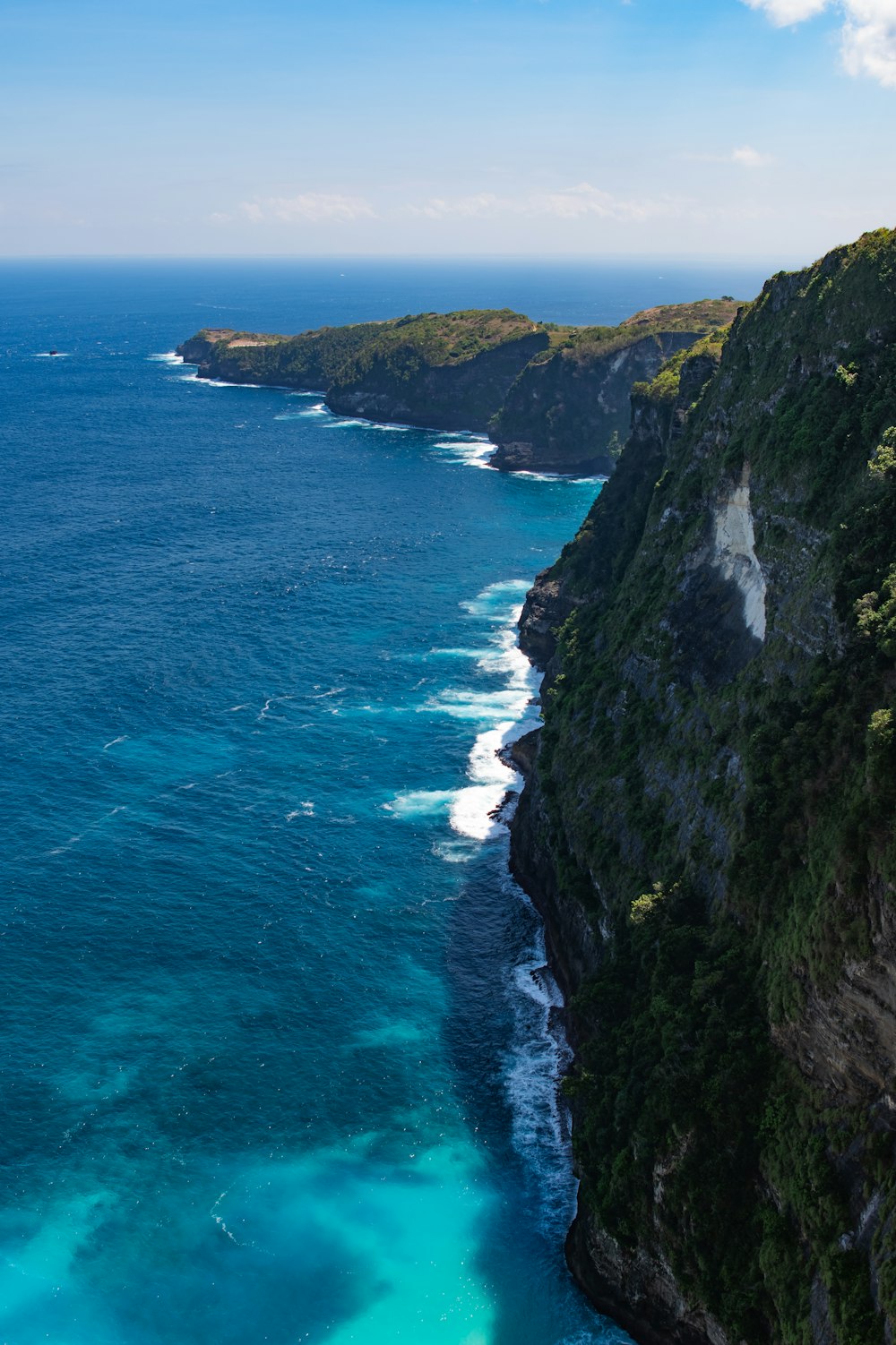 a cliff with a body of water below