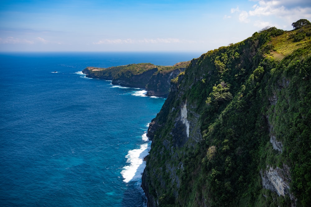 a cliff with a body of water below