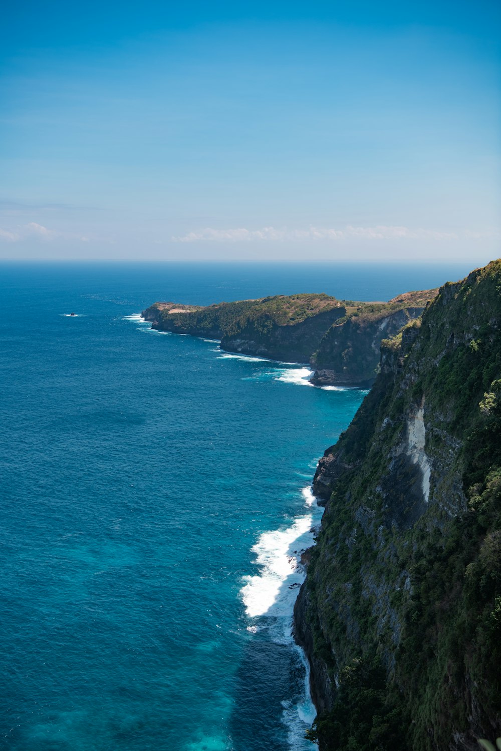 a cliff with a body of water below