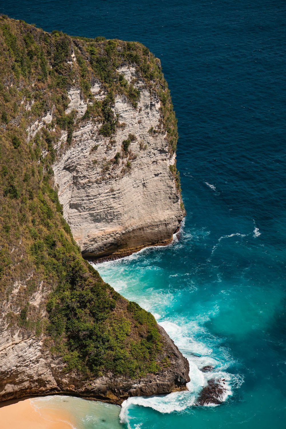 a cliff with a body of water below