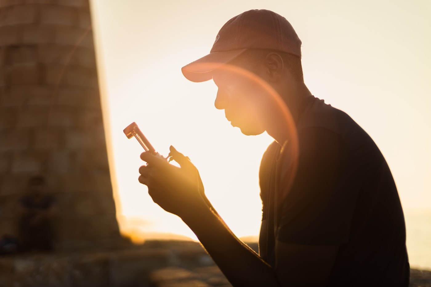 A runner checks activity stats on a smartphone during an outdoor workout.