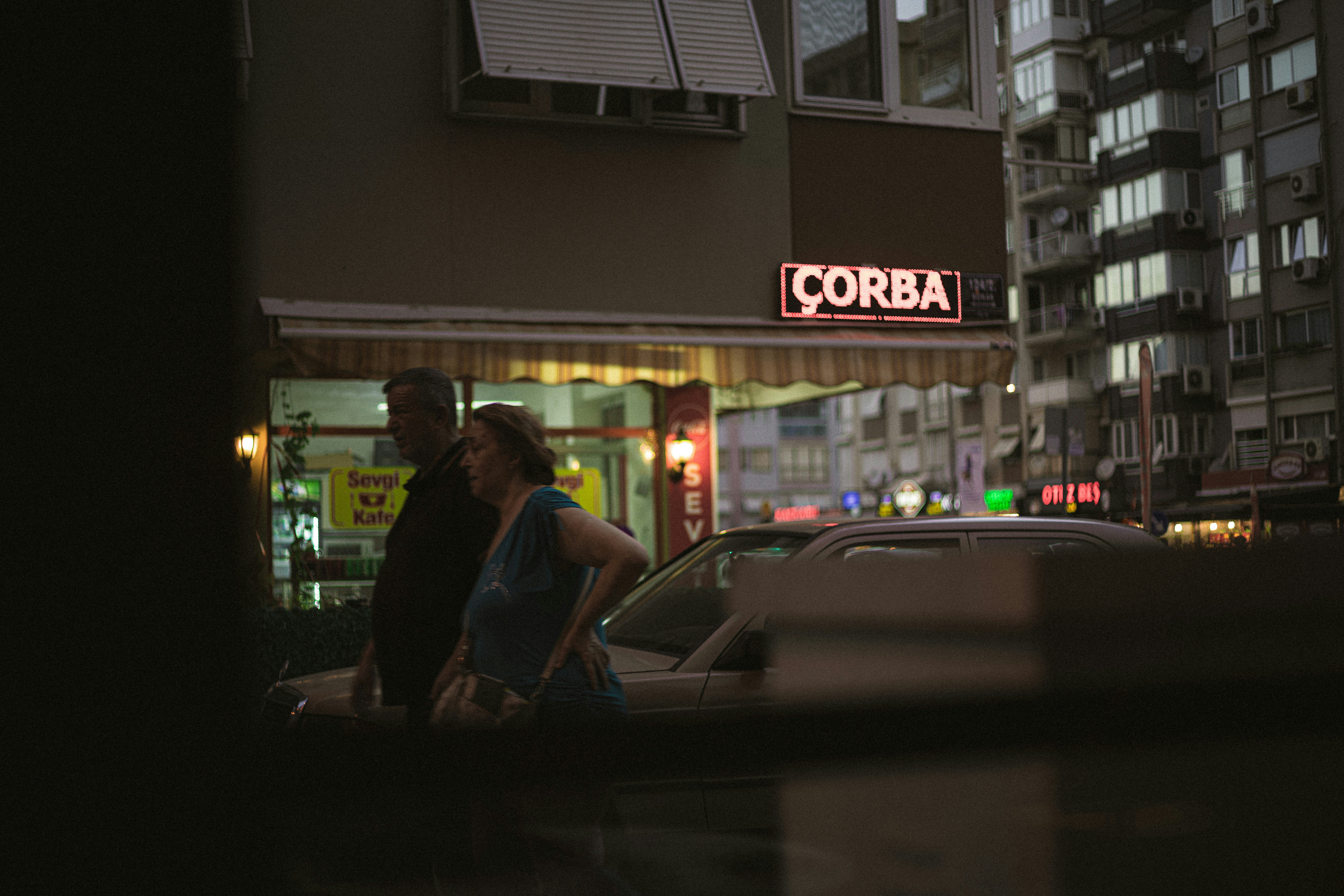 a man and woman walking down a street