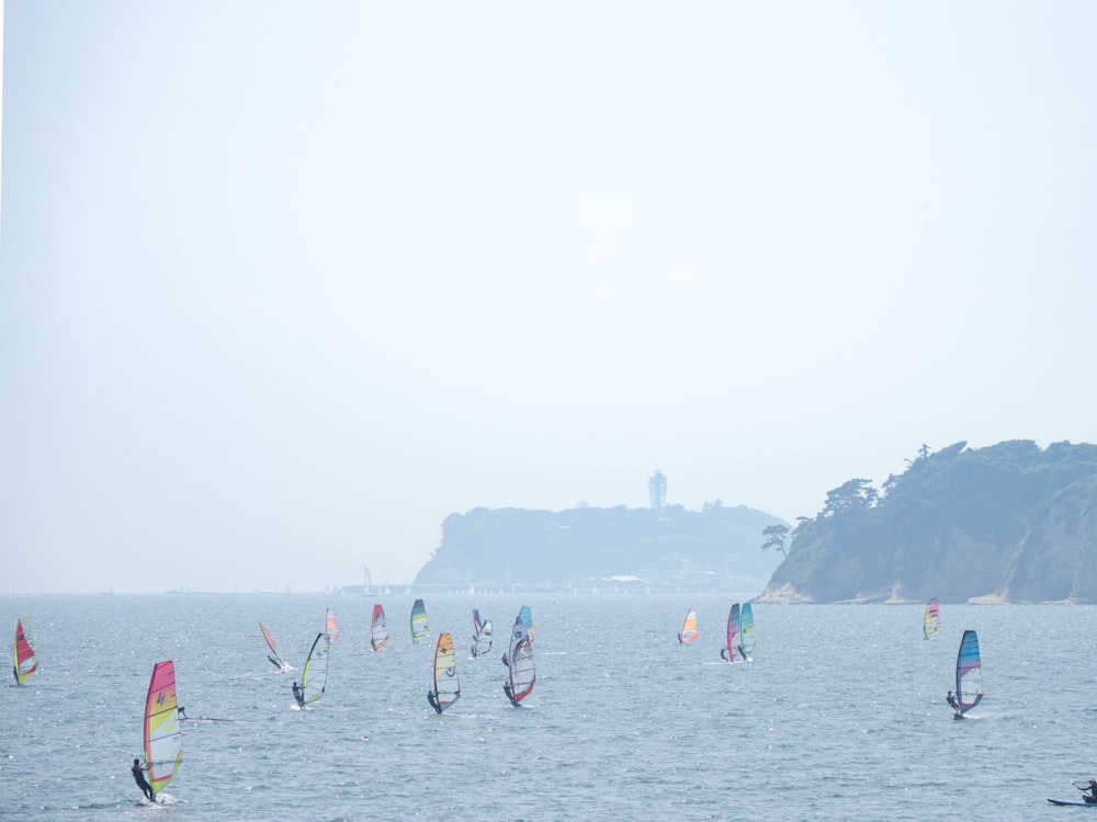 a group of people sail on the water