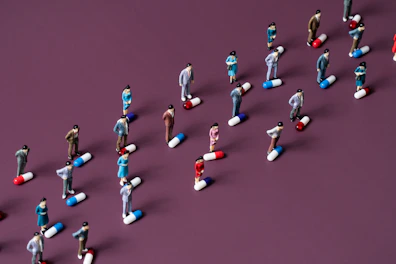 Top-down view of geeky miniature figures arranged on a textured gray surface.