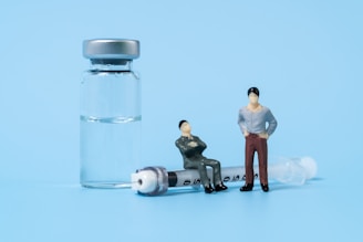a few people standing next to a glass container