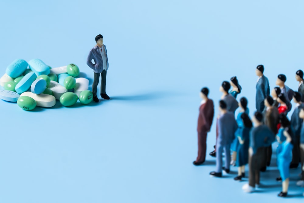 a person standing on a group of people holding balloons