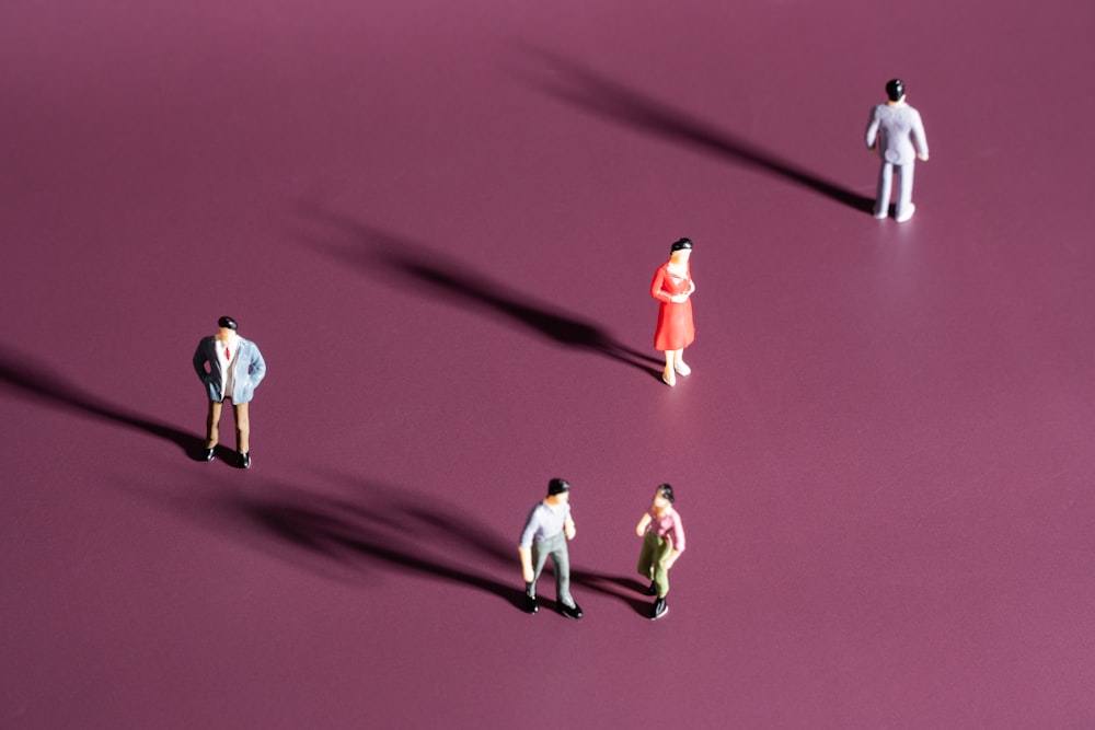 a group of people walking on a red carpet