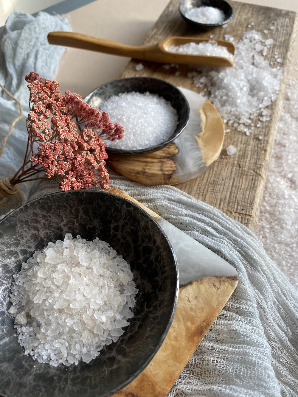 Bowls of coarse bath salt with dried flowers