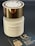 A white bottle of perfume labeled Andromeda by Tiziana Terenzi with a gold-colored cap. The bottle is accompanied by a black business card for UR Perfume, featuring QR codes and social media handles.
