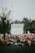 A cozy outdoor scene at the Tiger Drive-In with families watching a student film under string lights and a twilight sky.