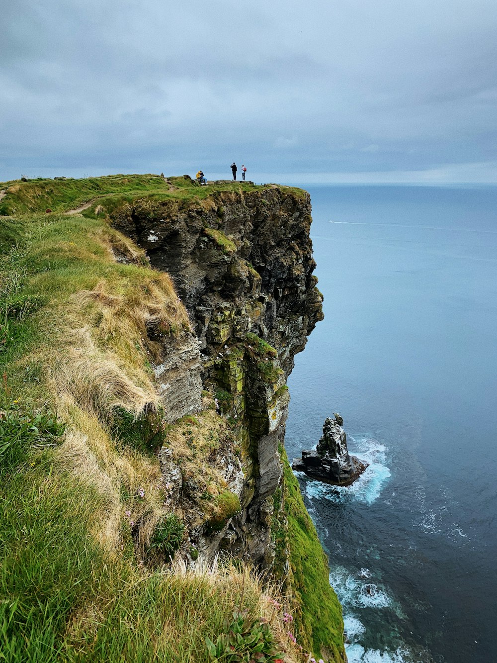 a group of people on a cliff