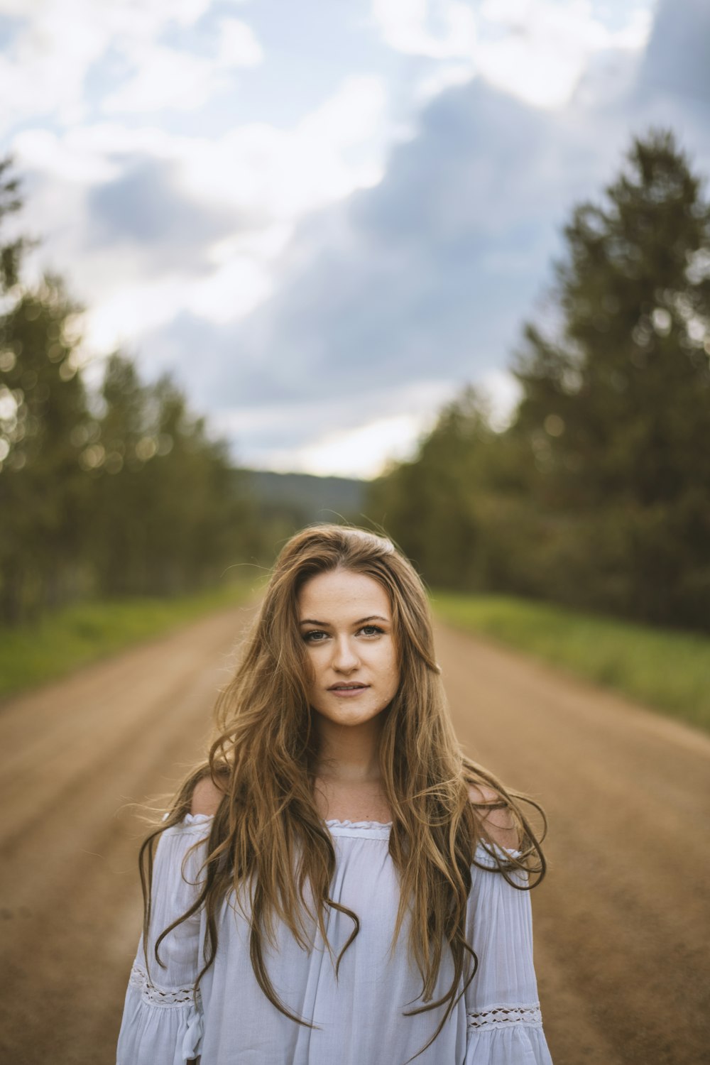 a person standing on a dirt road