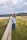 a woman standing on a wooden fence