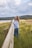 a woman standing on a wooden fence