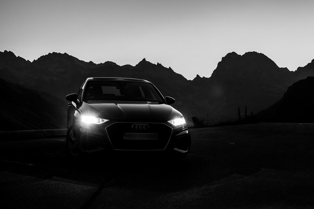 a car on a road with mountains in the background