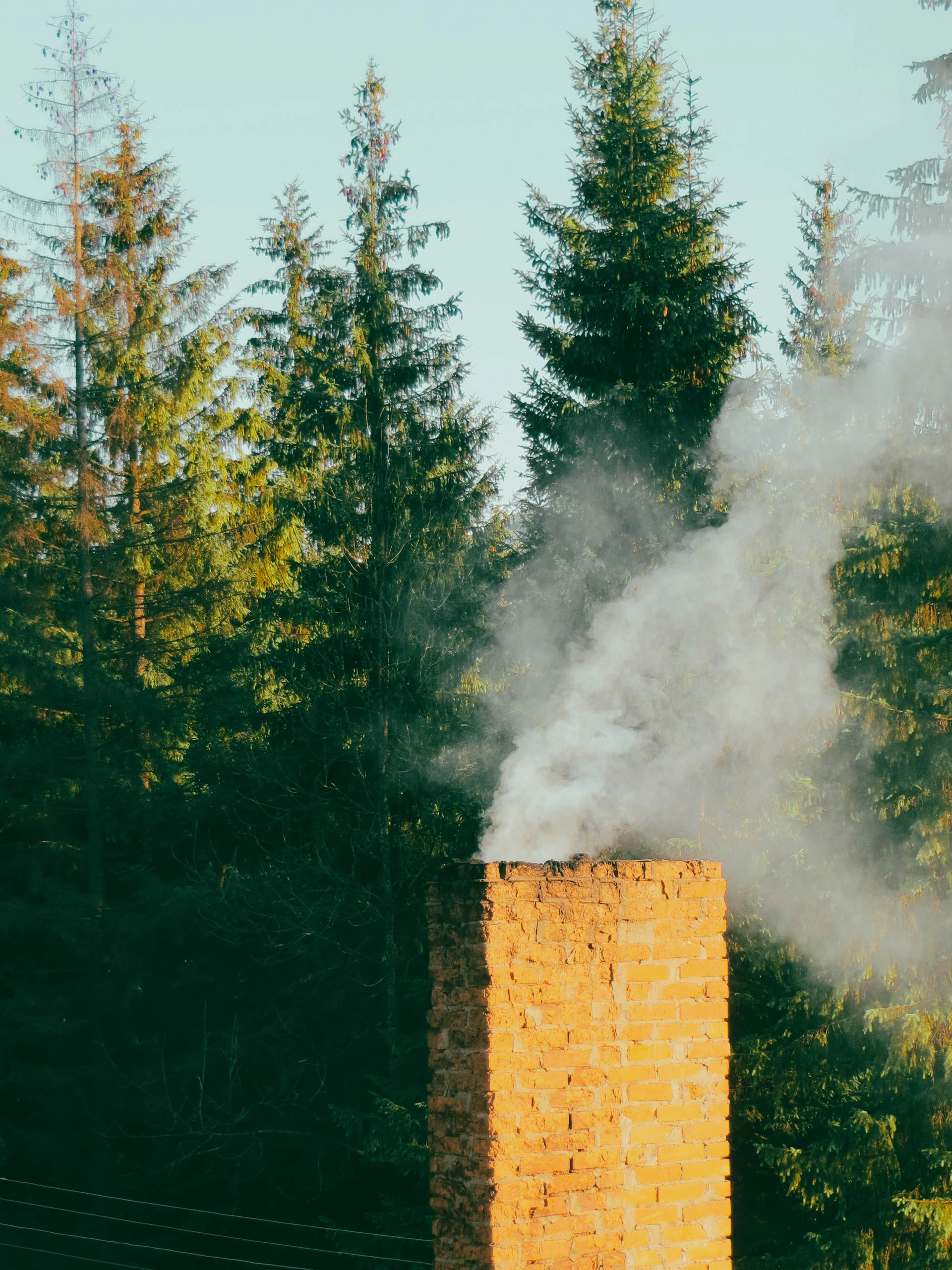 a brick chimney with a fire in the background