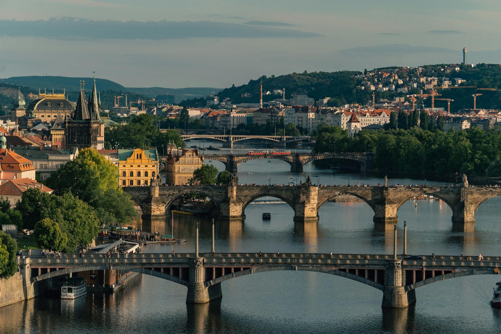 a bridge over a river with a city in the background