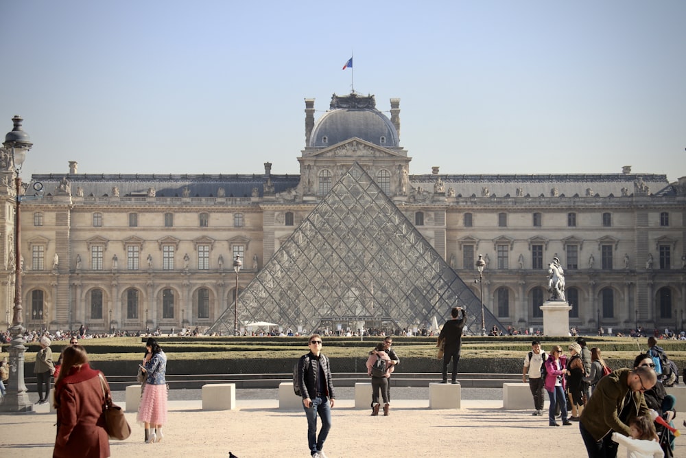 a large building with a dome and statues in front of it