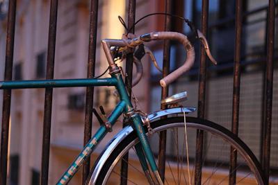 a bicycle parked in a fence