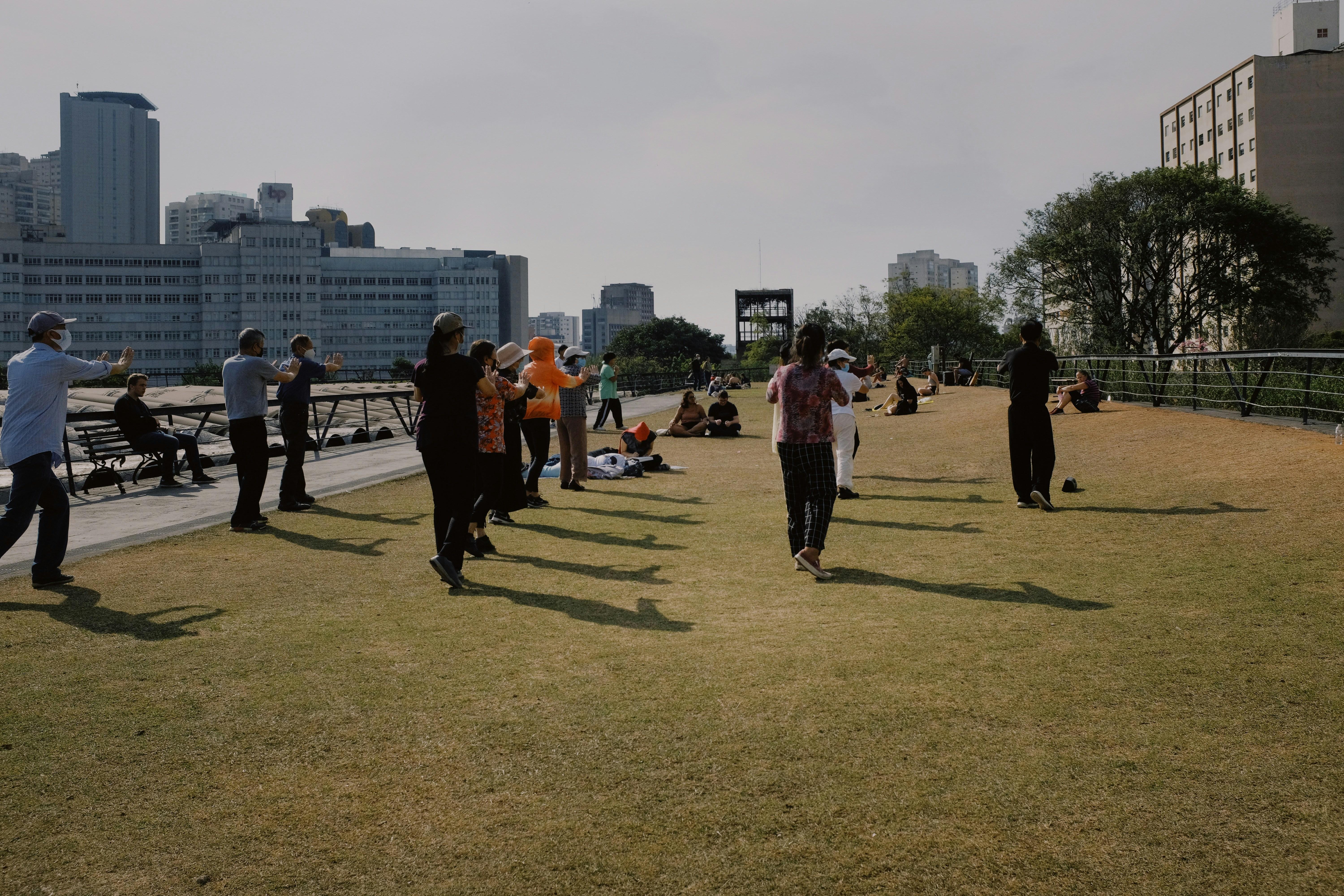 a group of people walking on a grass field