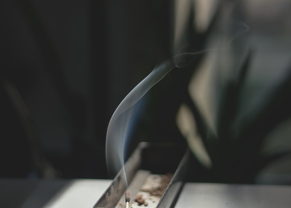 a close-up of a person holding a cigarette