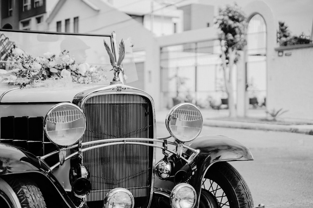 a black and white photo of a motorcycle parked on the side of a street