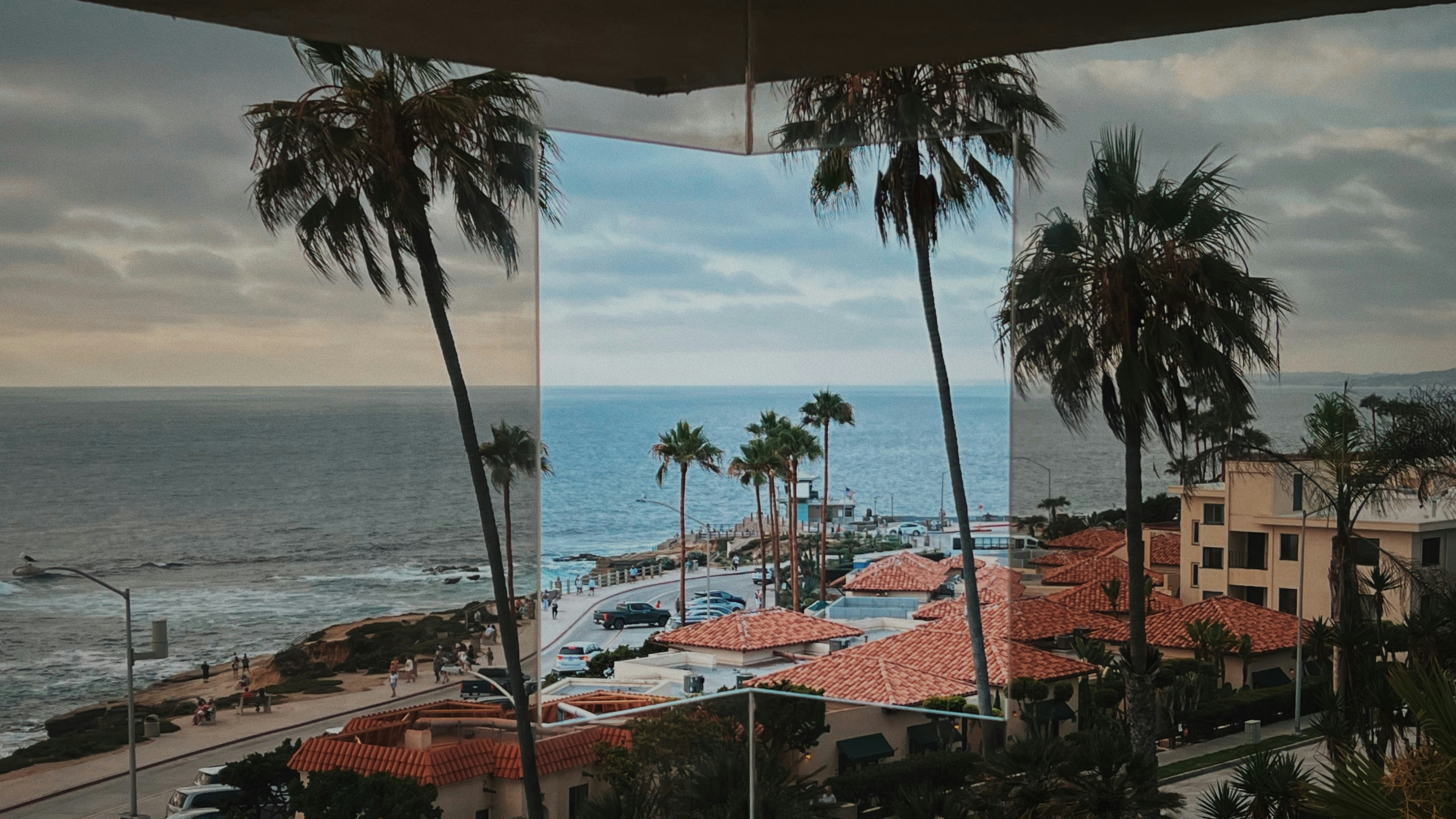 a beach with palm trees and buildings