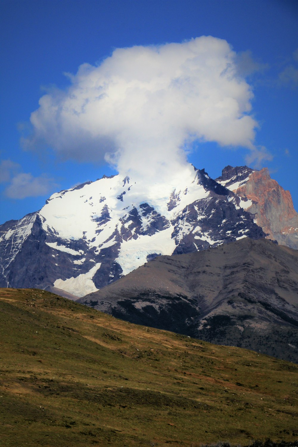 a mountain range with clouds