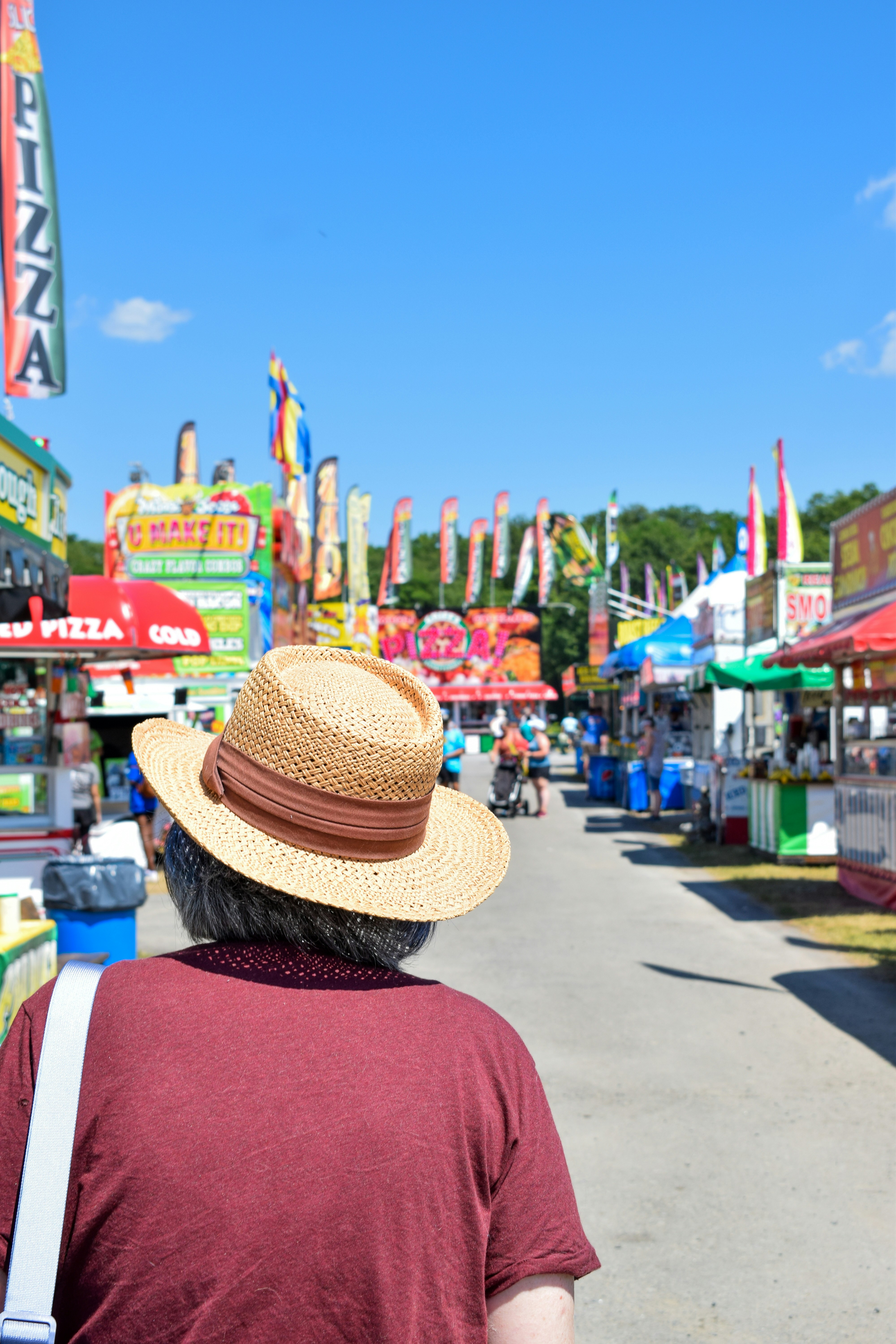 a person in a hat looking at a carnival